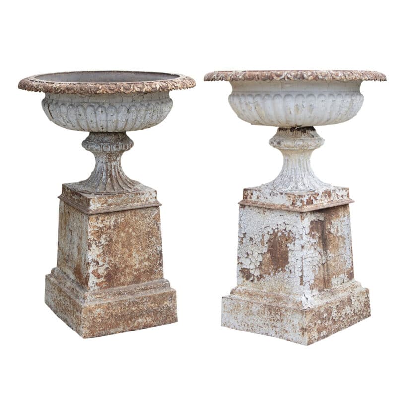 antique cast iron urns on pedestals